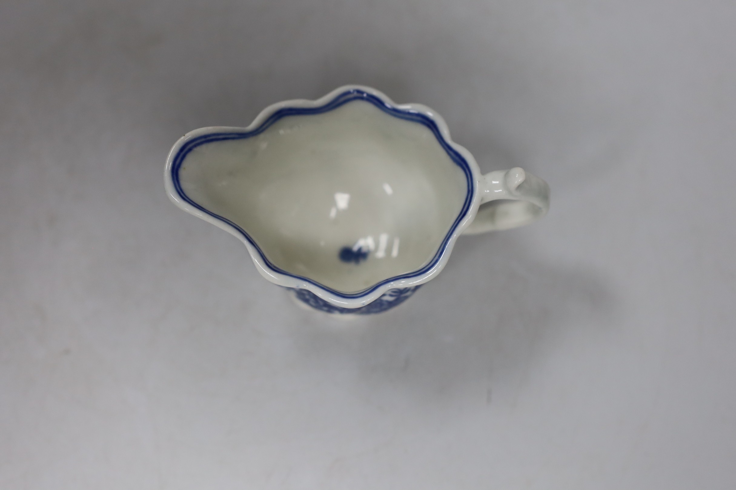 An 18th century Caughley Low Chelsea ewer printed with flowers, 6.5 cms high